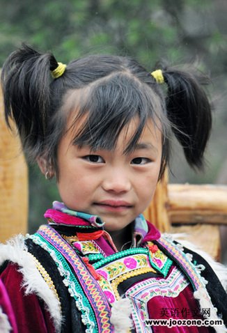 A girl wears traditional Qiang clothes in a village in Aba Tibetan and Qiang autonomous prefecture, Southwest China\s Sichuan province on May 10, 2010.